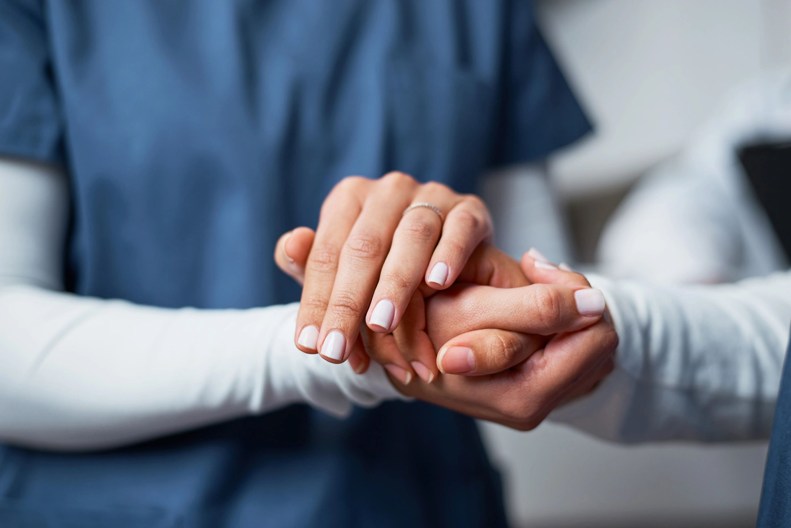 Hands clasped together representing trust and support in concierge medicine
