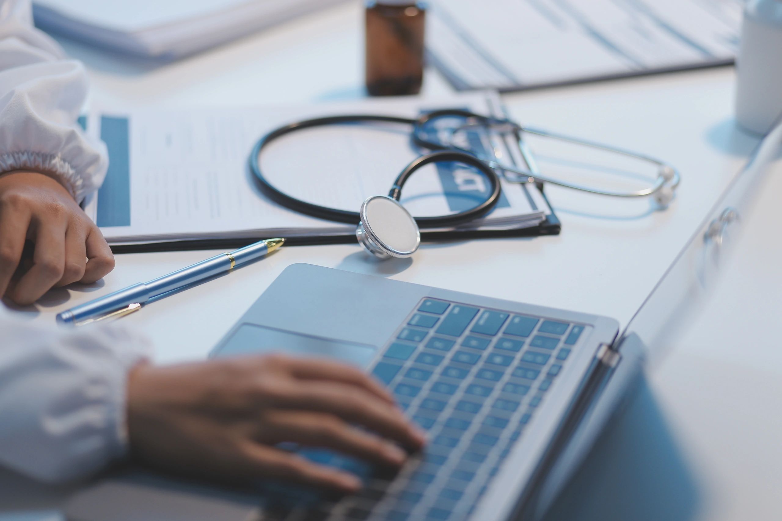 Medical office desk with stethoscope and documents