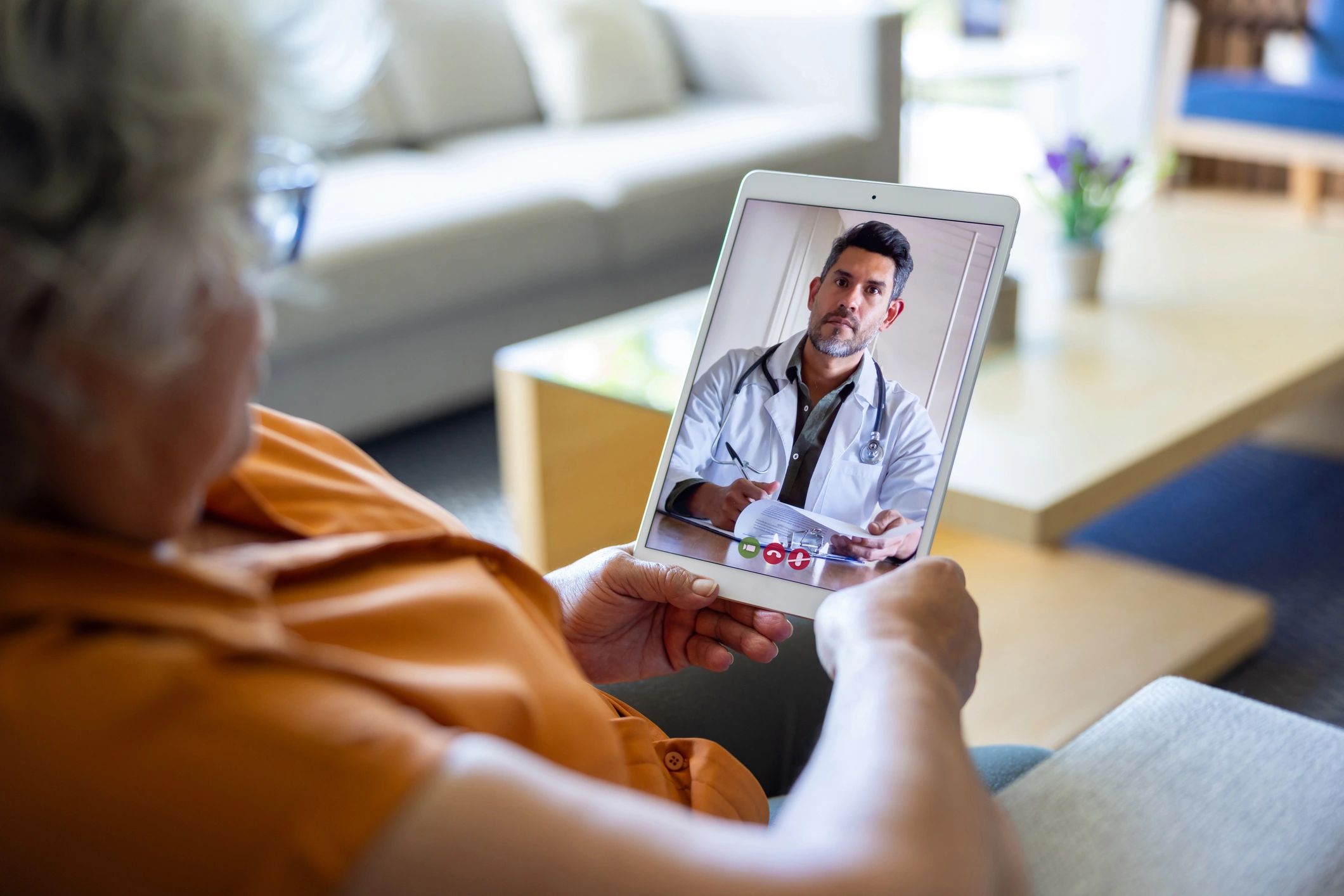 Elderly patient having a telemedicine consultation via tablet